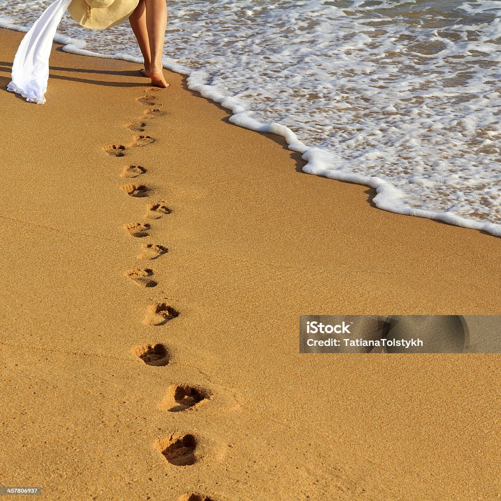 Footprints Woman is walking to the sea Beach Stock Photo