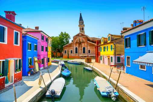 Venice landmark, Burano island canal, colorful houses church and boats, Italy. Long exposure photography