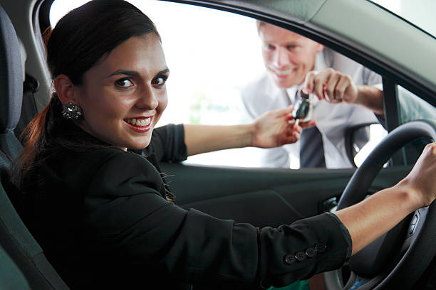 istock Young woman buying a new car 457812057