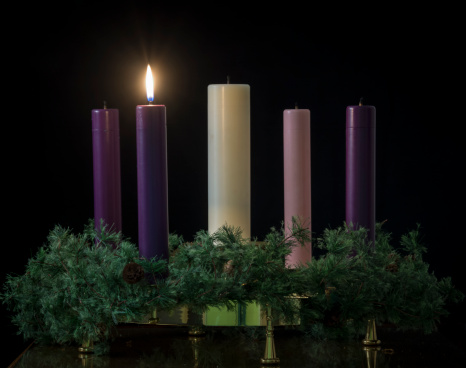 First of five candles lit on an advent wreath