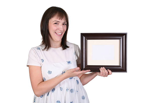 istock Woman Holding A Blank Picture Frame 457834781