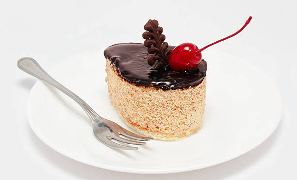 istock Cake icing with cherry on the plate isolated 457837935