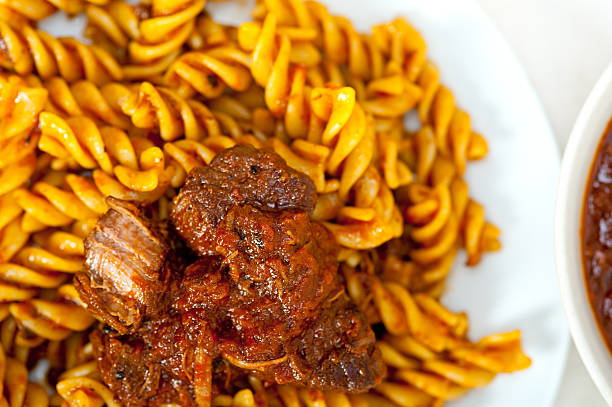 fusilli pasta al dente with neapolitan style ragu meat sauce very different from bolognese style