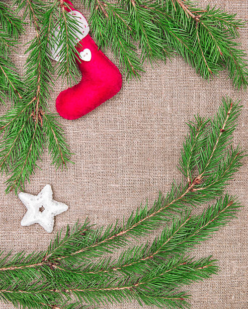 istock Christmas decoration with fir branches and red sock on burlap 457855689