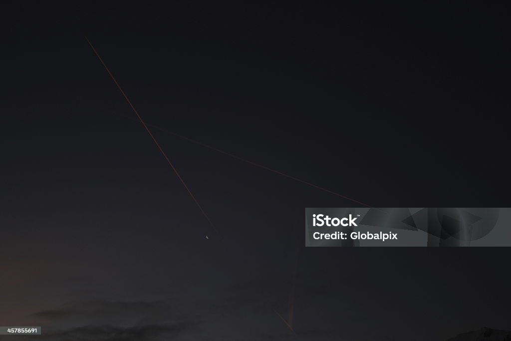 Sombre ciel clair de lune, Rouge buée Trail d'un avion - Photo de Au loin libre de droits