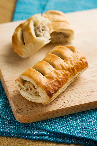 istock Sausage rolls pastry snacks with meat on a wooden surface 457900829