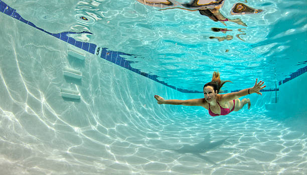 istock Woman in a Red Bikini Swimming Underwater 457920019