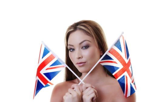 woman waving a british flag about in the air