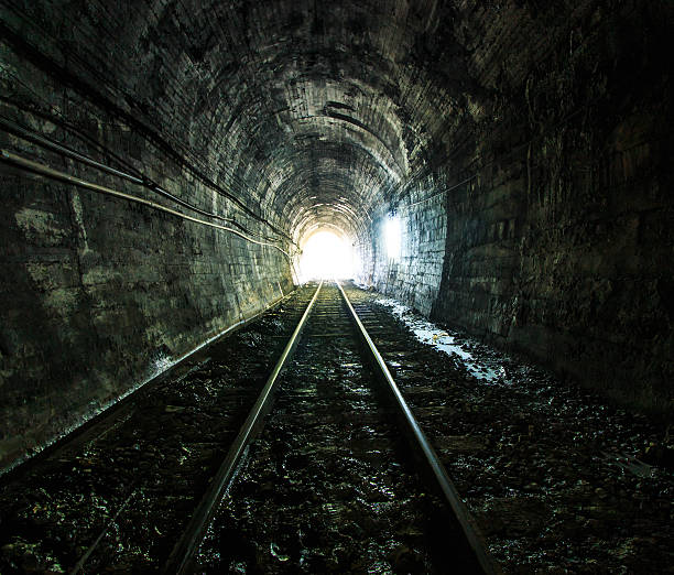 istock Light at the end of railroad tunnel. Natural lighting. 457923799