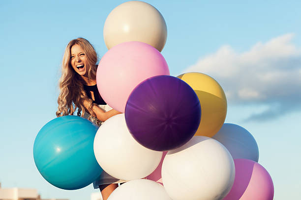 Szczęśliwa młoda kobieta z kolorowych balonów lateksowych – zdjęcie