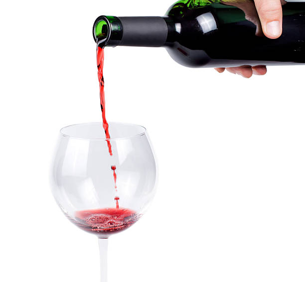 istock Pouring red wine into a wineglass 457934353