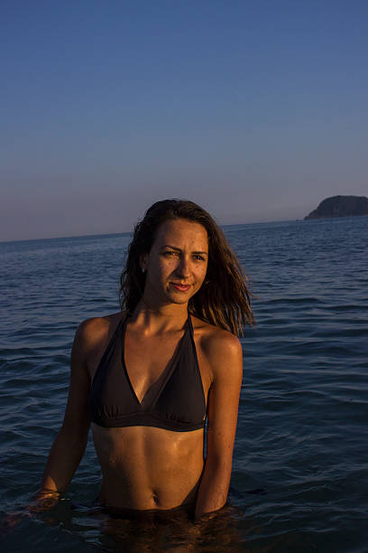 istock Sexy wet brunette posing in the sea 457943989