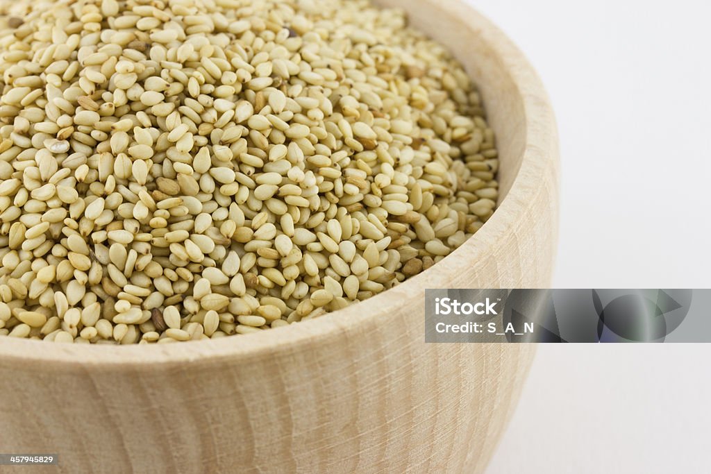 sesame Sezam in wood pot isolated on a wjite background Cooking Stock Photo