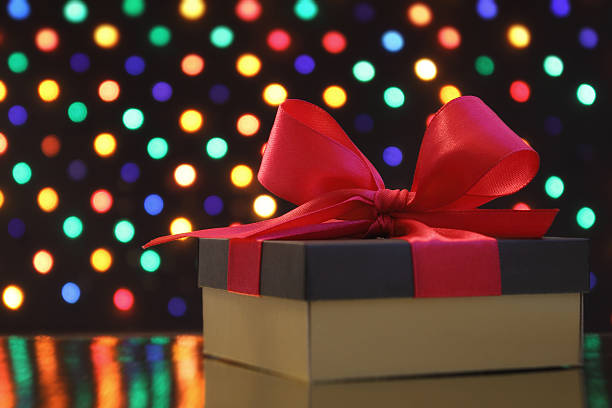 istock Gift box in front of a festive soft-focus background 457946137
