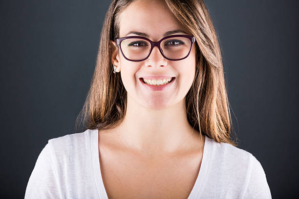 istock Smiling Young Woman on Dark Background 457947969