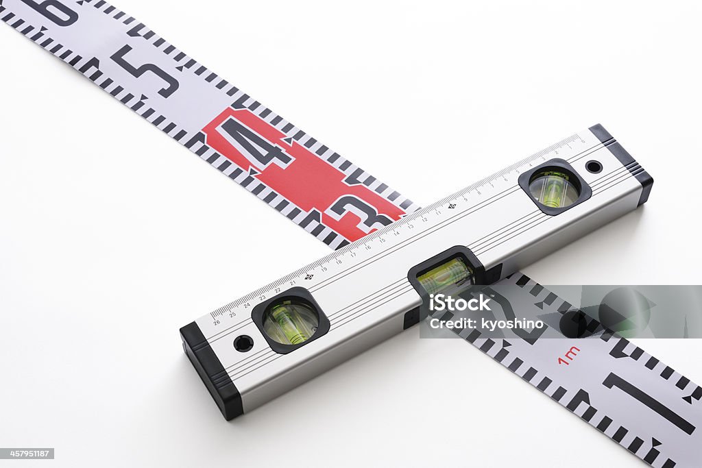 Level indicator with tape measure on white background Block level indicator in three directions with tape measure isolated on white background with clipping path. Accuracy Stock Photo