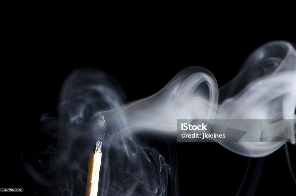Smoking Matchstick Smoking matchstick on black background. Plenty of copy space. Match - Lighting Equipment Stock Photo
