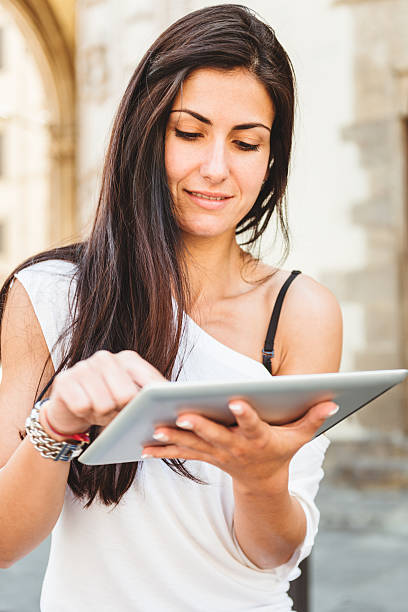 istock woman using a digital tablet on the city 457951549