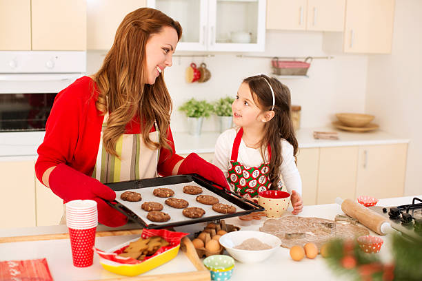 istock Mother and daughter making cookies. 457973521