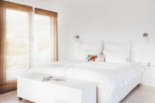 istock Bed and bench in white bedroom 457977291