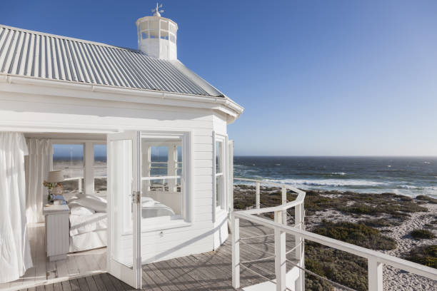 White bedroom overlooking ocean  beach house stock pictures, royalty-free photos & images