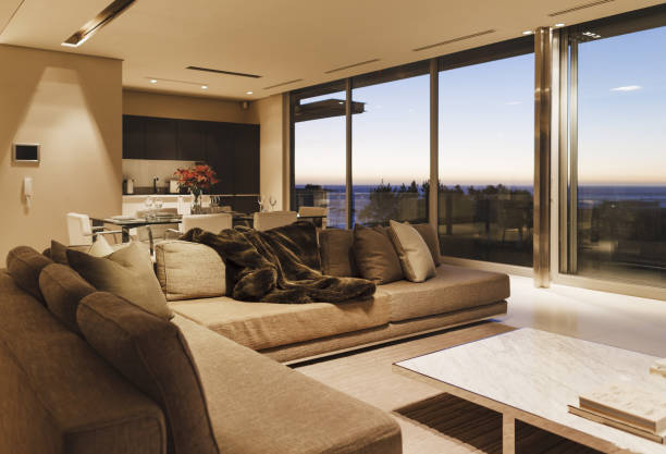 istock Modern living room overlooking ocean at sunset 457977937