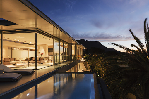 Modern house overlooking mountains at dusk