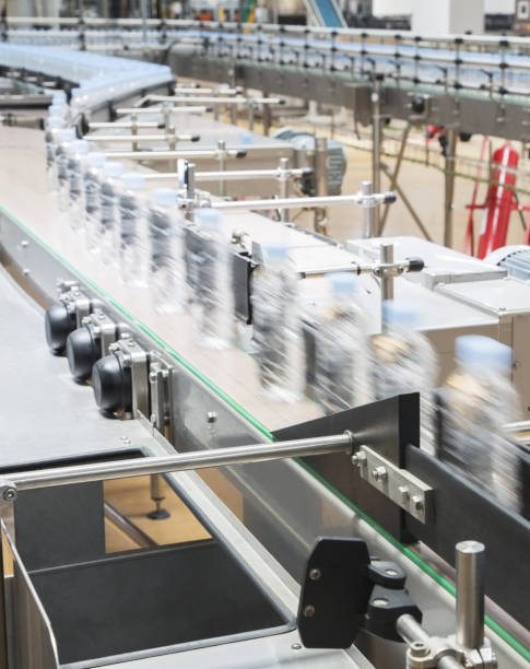 istock Bottles on conveyor belt in factory 457978421