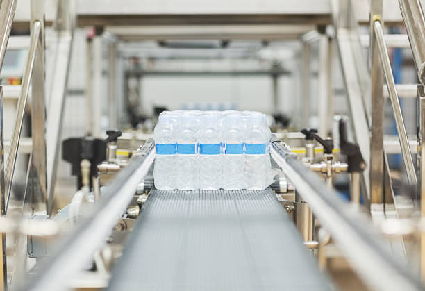 istock Water bottles on conveyor belt in factory 457978463