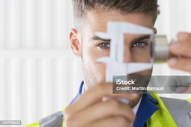 Worker Using Calipers In Factory Stock Photo - Download Image Now - 25-29 Years, Accuracy, Adult