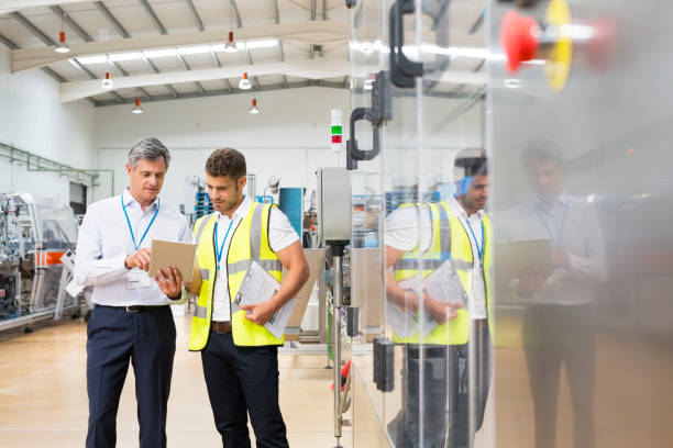 supervisor and worker using digital tablet in factory - 11334 стоковые фото и изображения