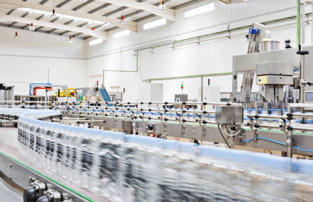 istock Bottles on conveyor belt in factory 457978593