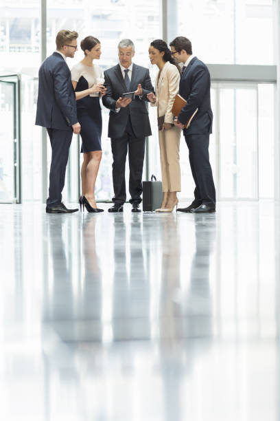 istock Business people talking in office lobby 457978967