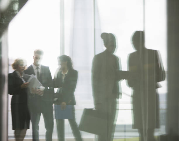 istock Reflection of business people talking in office 457979111