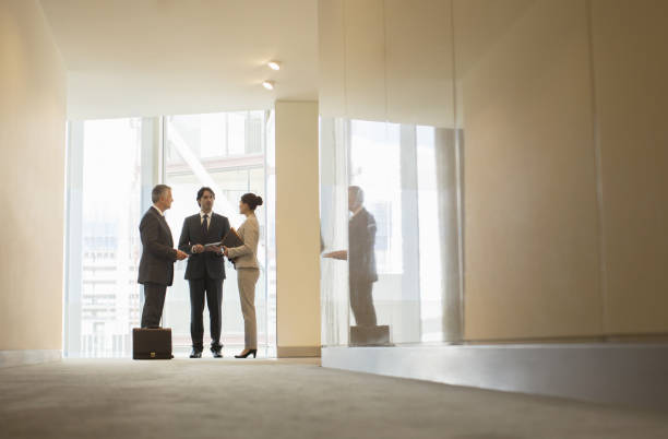 istock Business people talking at office window 457979269