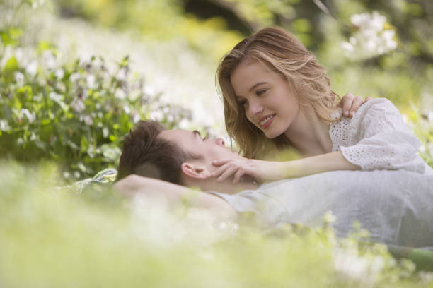 istock Couple relaxing together in grass 457979773