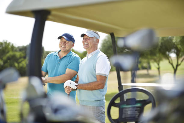 istock Senior men standing next to golf cart 457979933