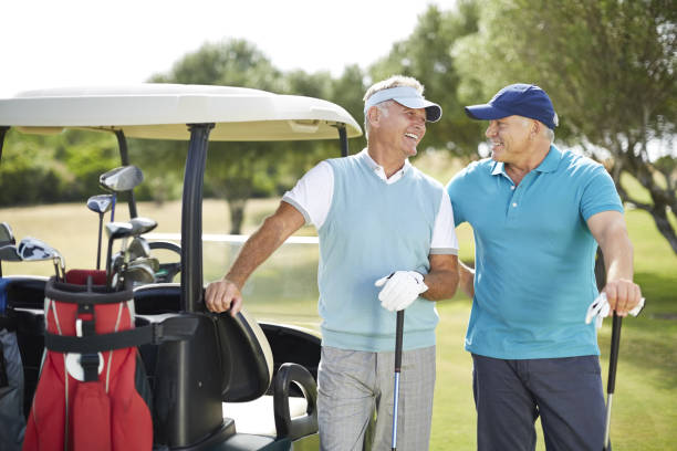 istock Senior men laughing next to golf cart 457980061