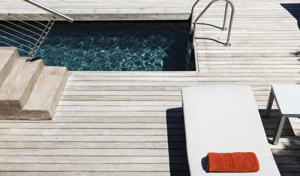 istock Pool and wooden deck of modern house 457980237