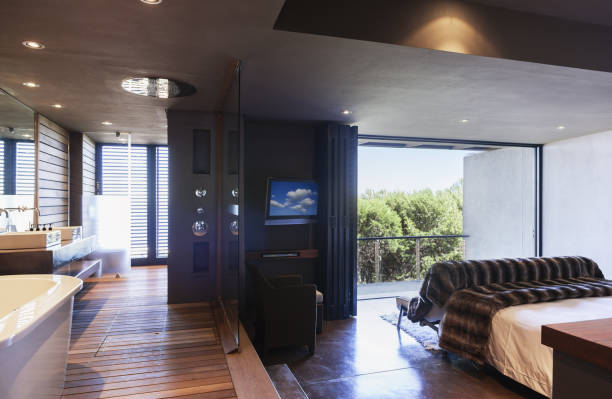 istock Glass wall separating master bedroom and bathroom 457980403