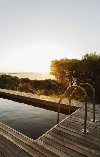 istock Sunset in background of lap pool 457980405