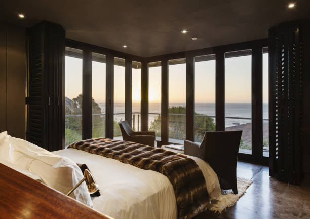 istock Luxury bedroom overlooking ocean at sunset 457980489