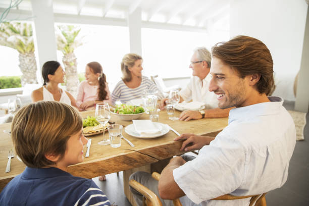 istock Multi-generation family eating together at table 457980597