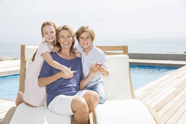 grandmother and grandchildren at poolside - grandson water waterfront portrait 뉴스 사진 이미지
