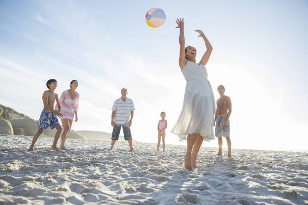 istock Family playing together on beach 457980961