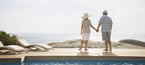 istock Older couple overlooking ocean from balcony 457981109