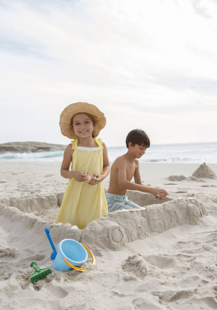 istock Children building sandcastle on beach 457981351