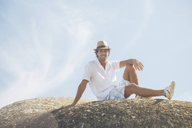 istock Man sitting on rock formation 457981451