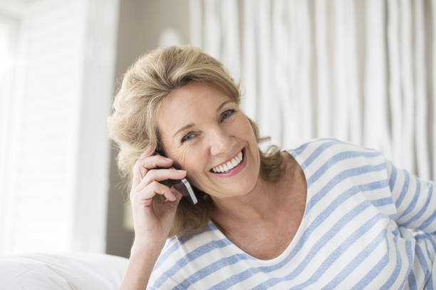 istock Older woman talking on cell phone 457981603