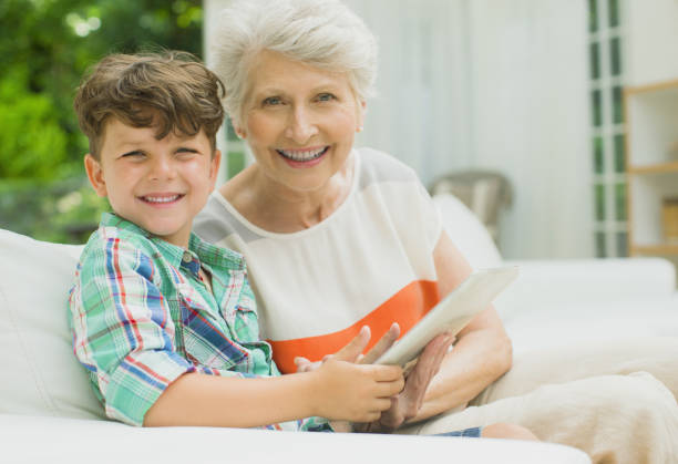 istock Older woman and grandson using digital tablet 457981961